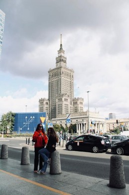 Nicole in front of the Palace of Culture and Science with a friend